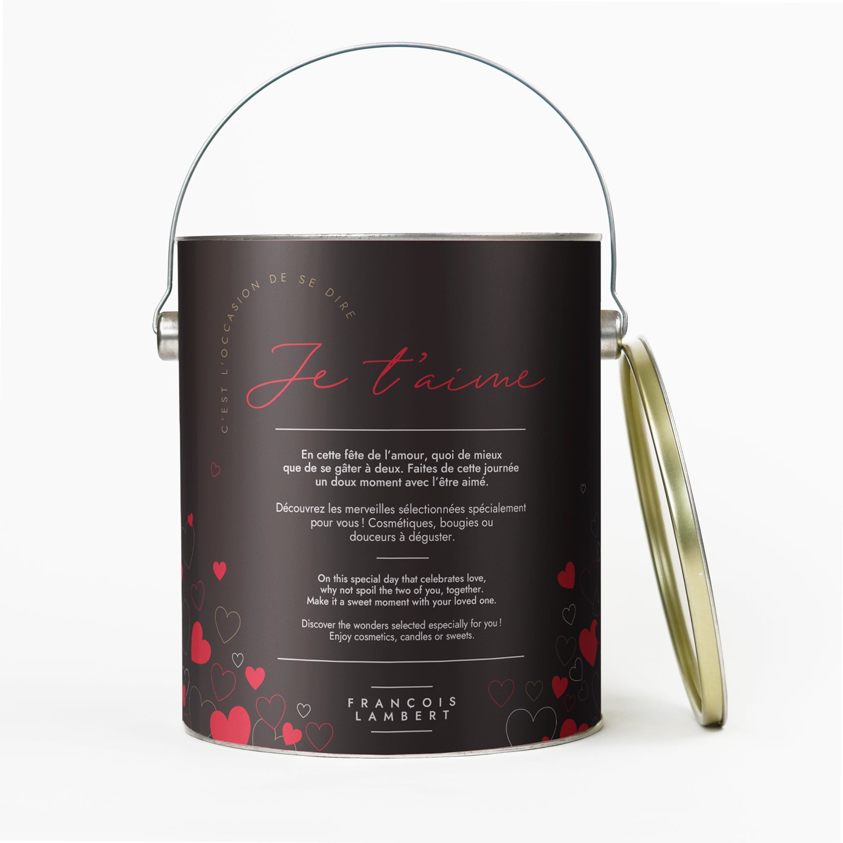 Coffret cadeau cylindrique pour la Saint-Valentin avec l'inscription "Je t'aime" en lettres rouges, entouré de cœurs et un texte bilingue français-anglais. Poignée métallique sur le dessus et marque "FRANÇOIS LAMBERT" en bas.